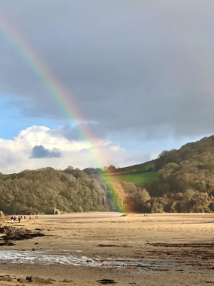 Beach rainbow, Devon, UK